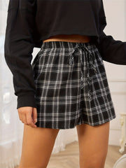 Plaid drawstring waistline shorts with a tie detail.