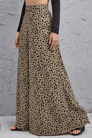 Spotted wide-leg palazzo trousers in a neutral tone with black animal print, flowing fabric.