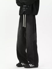 Black relaxed fit wide-leg jeans with drawstring and striped detail.