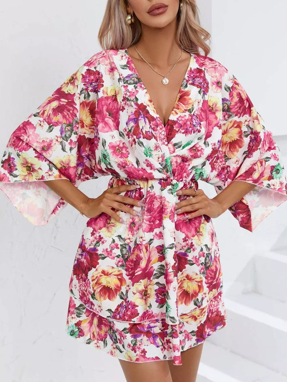 Floral ruffle hem mini dress with a V-neck and wide sleeves.