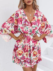 Floral ruffle hem mini dress with a V-neck and wide sleeves.