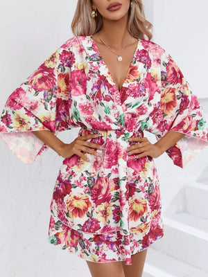 Floral ruffle hem mini dress with a V-neck and wide sleeves.