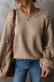 Mocha knit sweater with pearl embellishments on the sleeves and neckline.