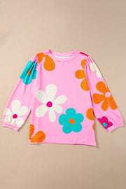 Pink long sleeve t-shirt with a bold floral print in orange, white, and teal.