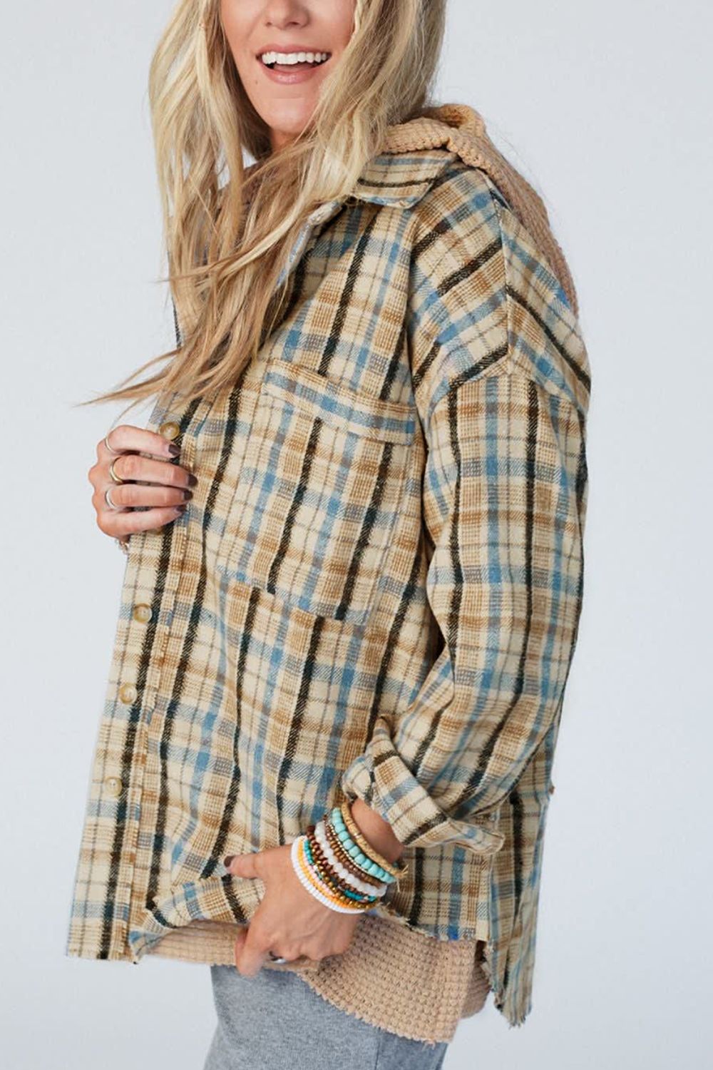 Textured plaid hooded overshirt with raw hem and button-up front.