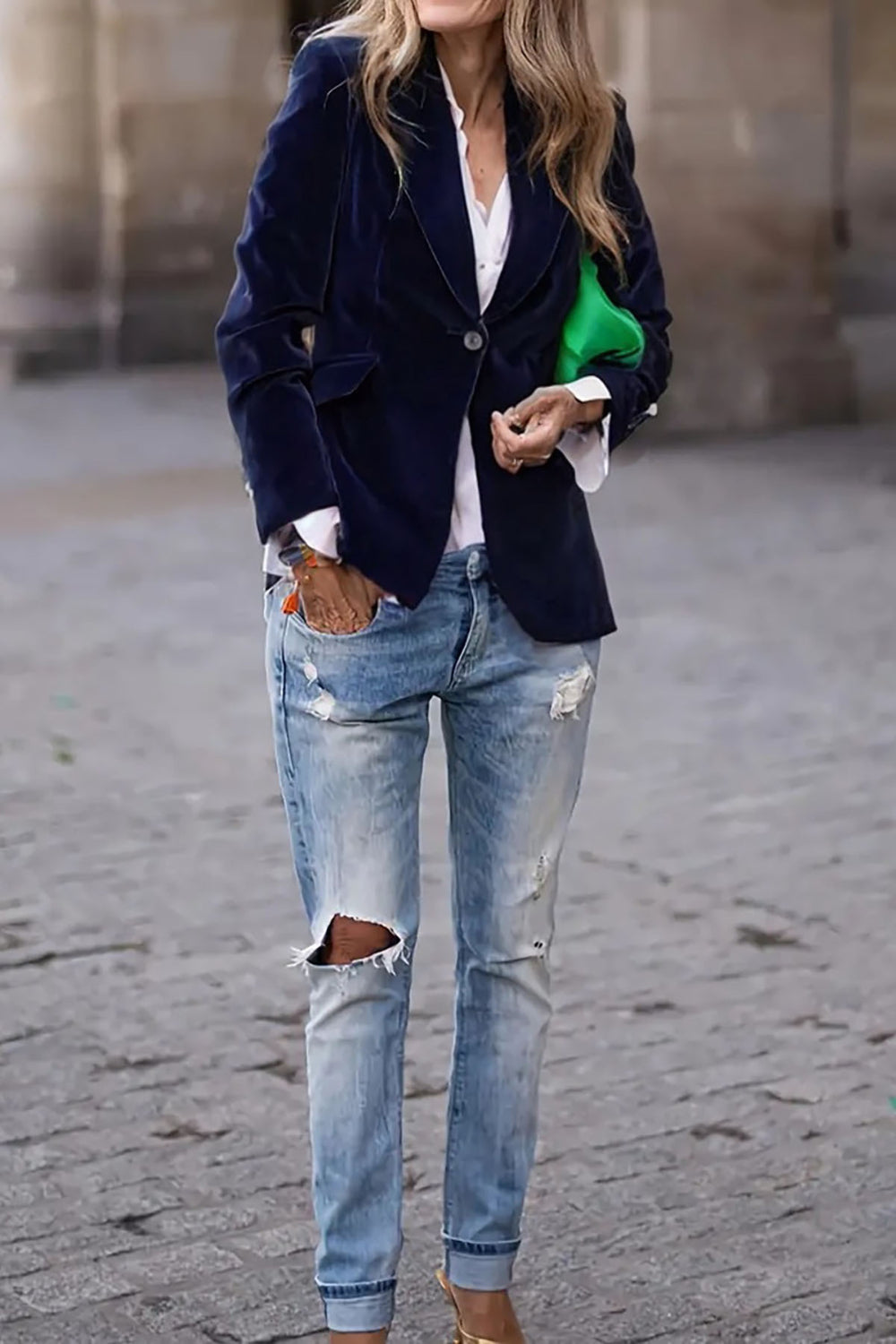 Navy velvet blazer with gold button detail and lapel collar, worn with a white shirt and ripped jeans.
