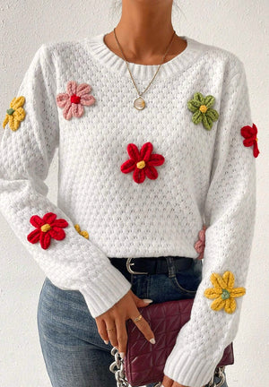White knit sweater with colorful crochet floral embellishments, crew neck, long sleeves.