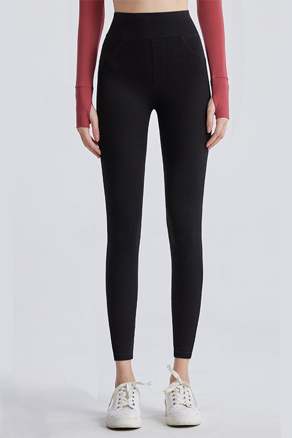 Black sculpting denim leggings with faux pockets and a high waist.