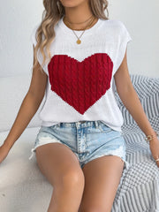 White cable knit sweater vest with a large red cable knit heart graphic.