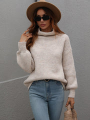 Beige ribbed knit turtleneck sweater with balloon sleeves and a relaxed fit.