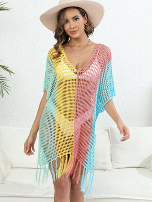 Colorblock crochet cover-up with fringe and V-neck in pastel shades of green, yellow, pink, and blue.