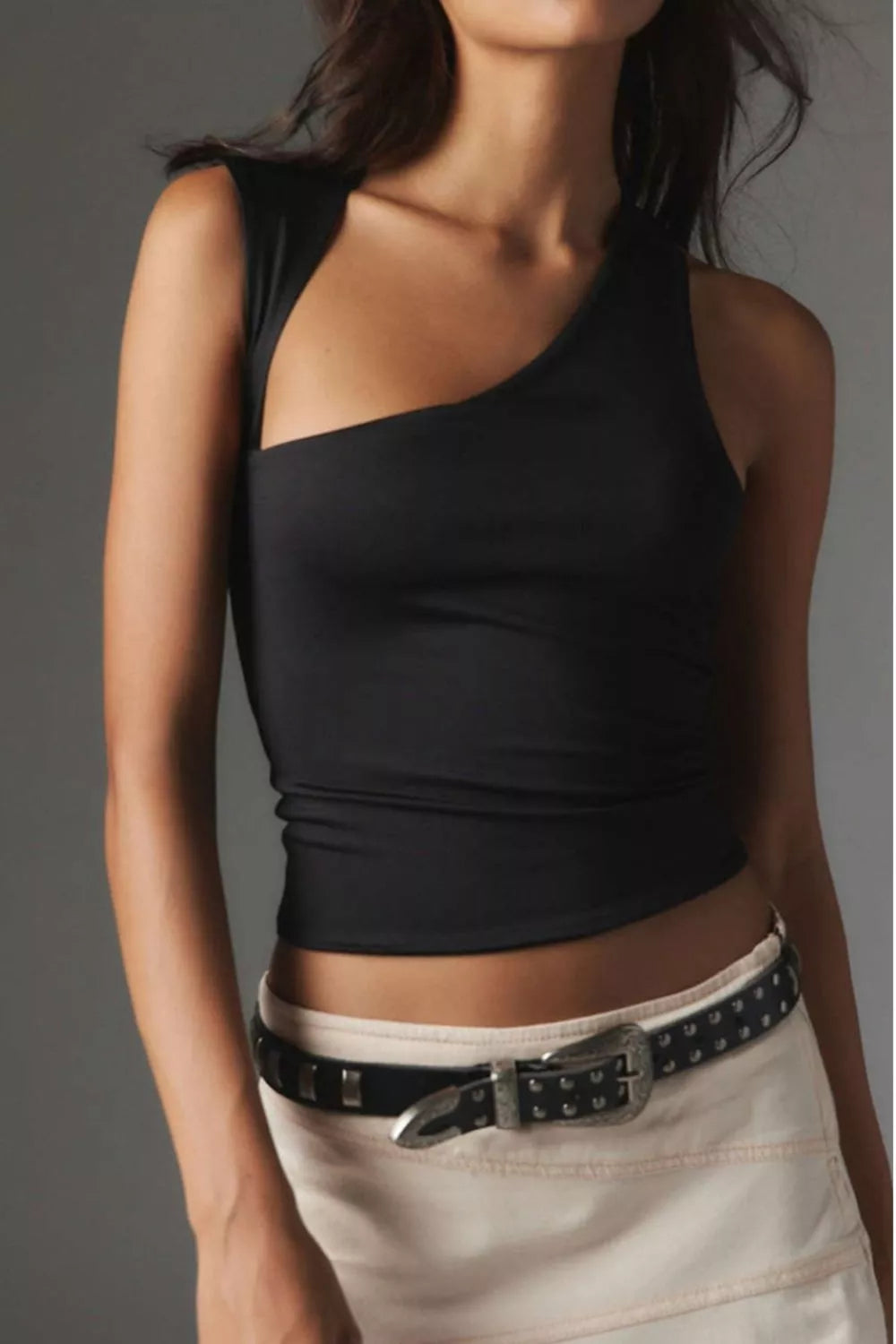 Black asymmetrical one-shoulder cropped tank top with cutout detail.