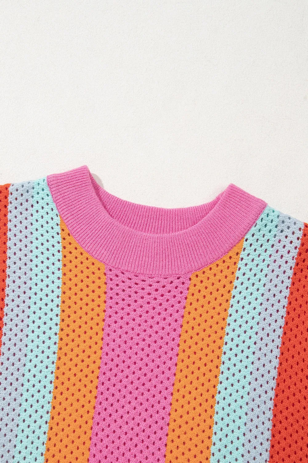 Geometric stripe openwork knit top with multicolor stripes and pink crew neck.