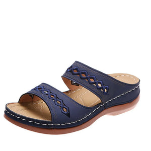 Navy embroidered strap comfort slides with a cushioned footbed and wedge heel.