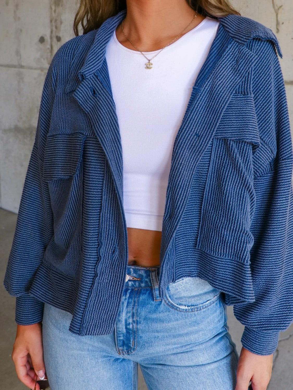 Peacock blue textured boxy utility shirt jacket with button front and chest pockets.