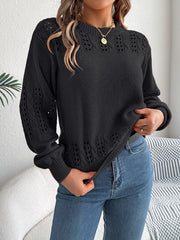 Black acrylic knit sweater with openwork detail on sleeves and neckline.