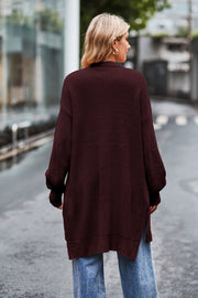Longline open-knit cardigan in wine with side slits and textured sleeves.