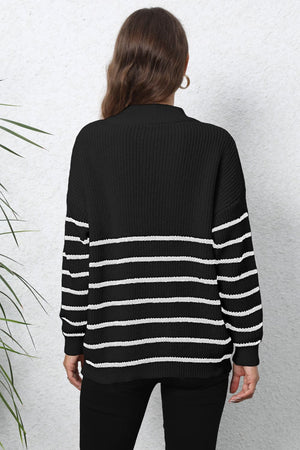 Black and white striped ribbed knit sweater with a quarter-zip neckline.