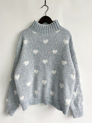 Mint blue acrylic turtleneck sweater with all-over white heart motif.