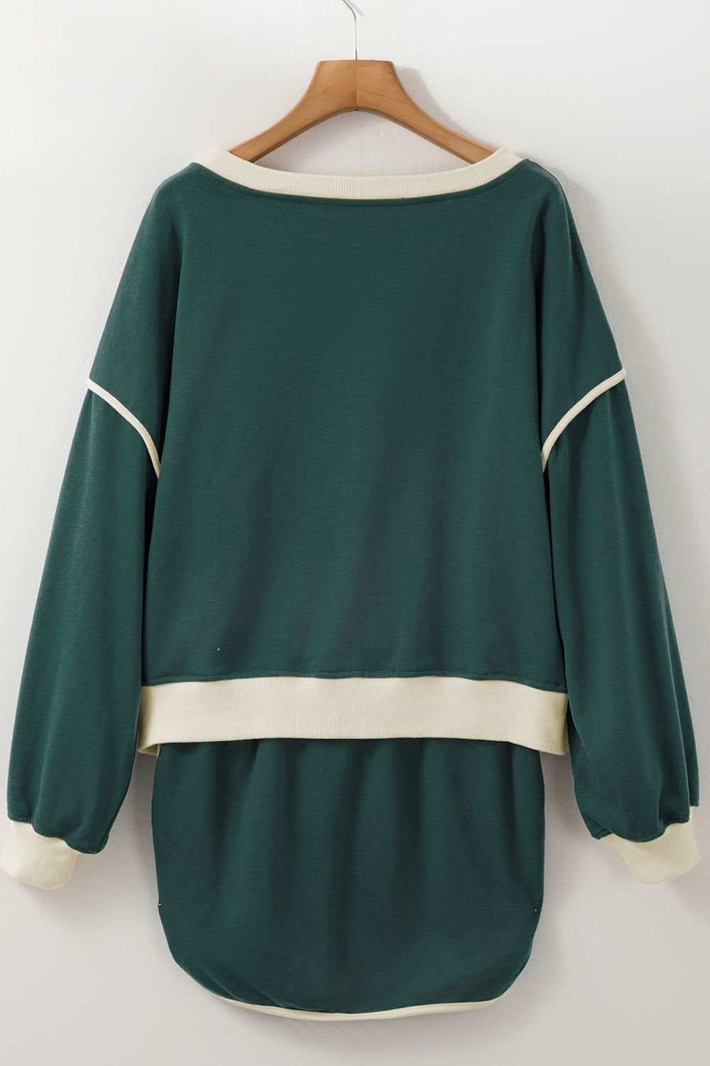 Dark green sweatshirt and skort set with cream contrast trim and neckline