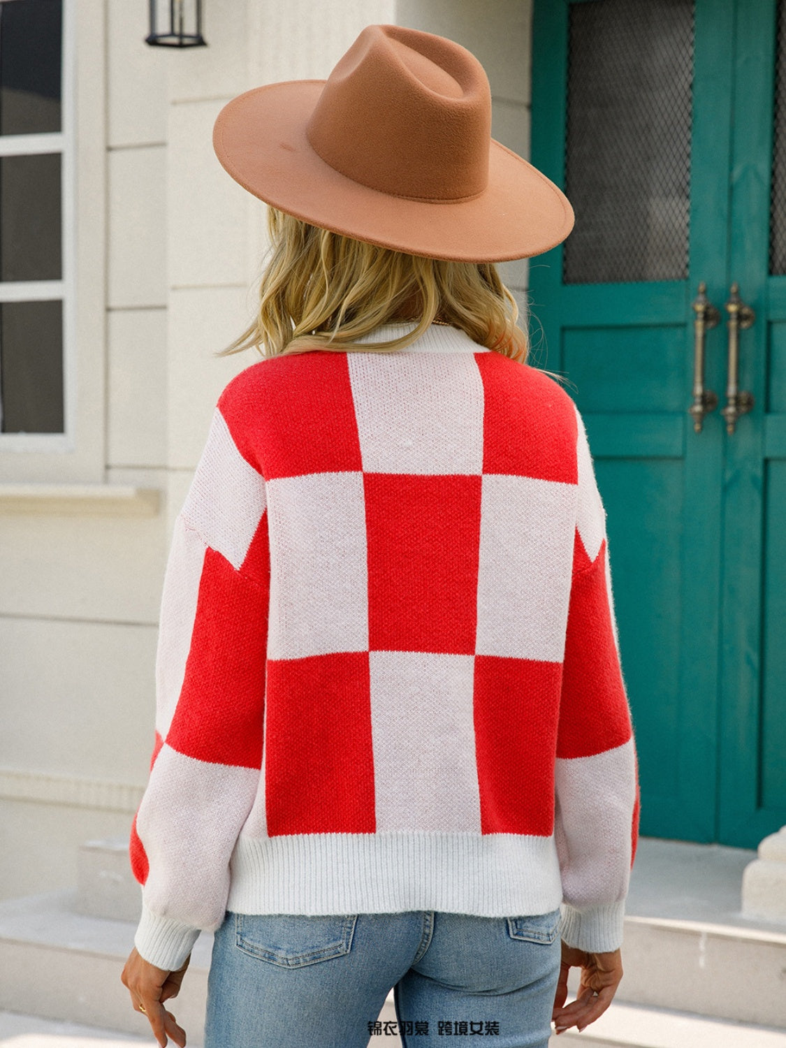 Checkerboard knit pullover sweater in red and white with balloon sleeves.