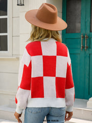 Checkerboard knit pullover sweater in red and white with balloon sleeves.
