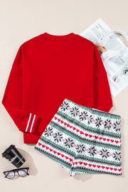 Red cotton sweatshirt with striped cuffs and festive snowflake and heart print shorts.
