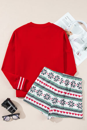 Red cotton sweatshirt with striped cuffs and festive snowflake and heart print shorts.