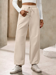 Tan balloon-leg sweatpants with drawstring waist and cuffed hems.