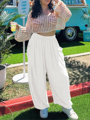White linen balloon trousers with cargo pockets and drawstring waist