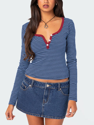 Striped long sleeve henley shirt with contrast collar and buttons in blue.