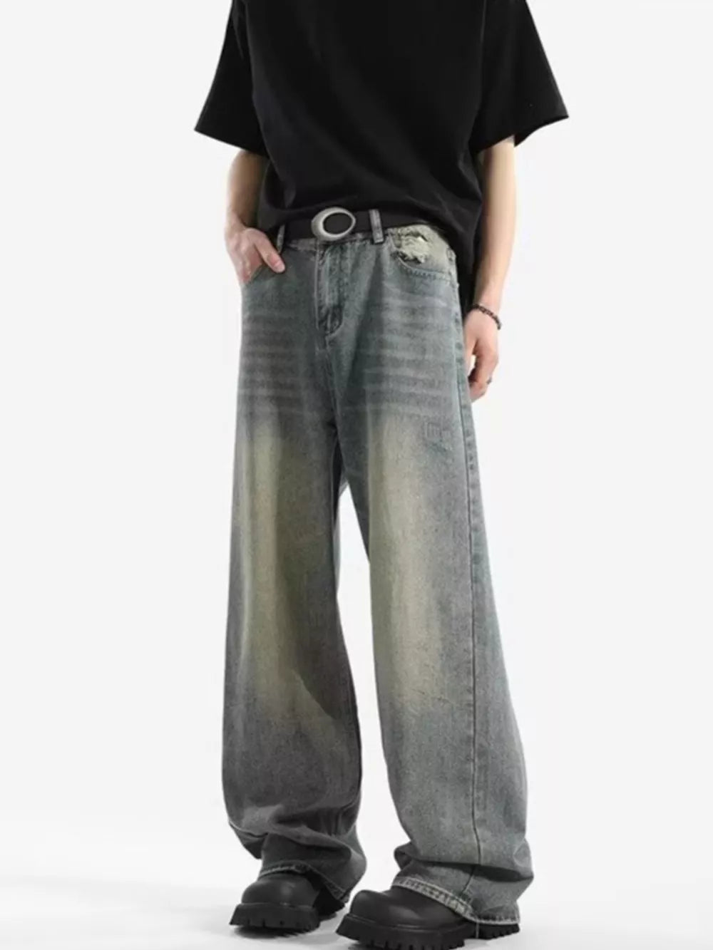 Men's relaxed fit vintage wash jeans with a baggy cut and distressed details.