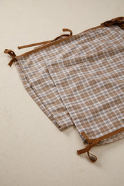 Plaid print casual pants with drawstring ties and brown trim.