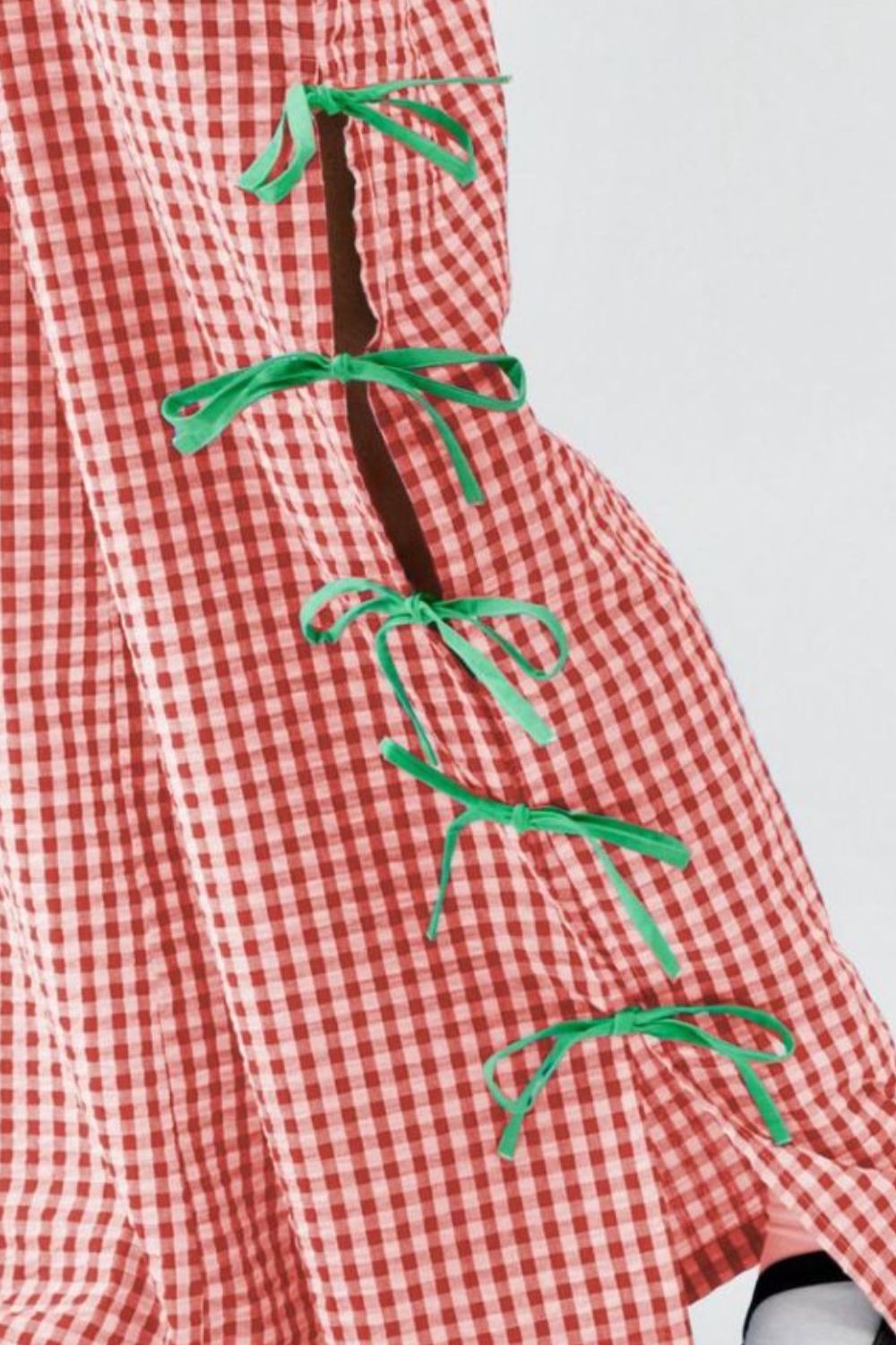 Scarlet gingham wide-leg trousers with green bow details on the side seam.