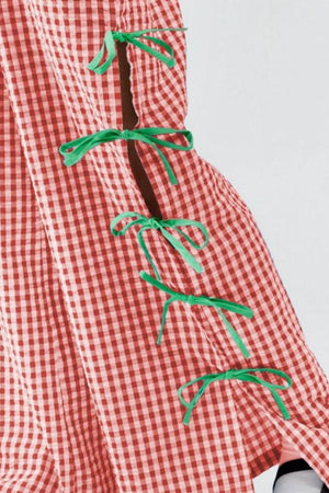 Scarlet gingham wide-leg trousers with green bow details on the side seam.