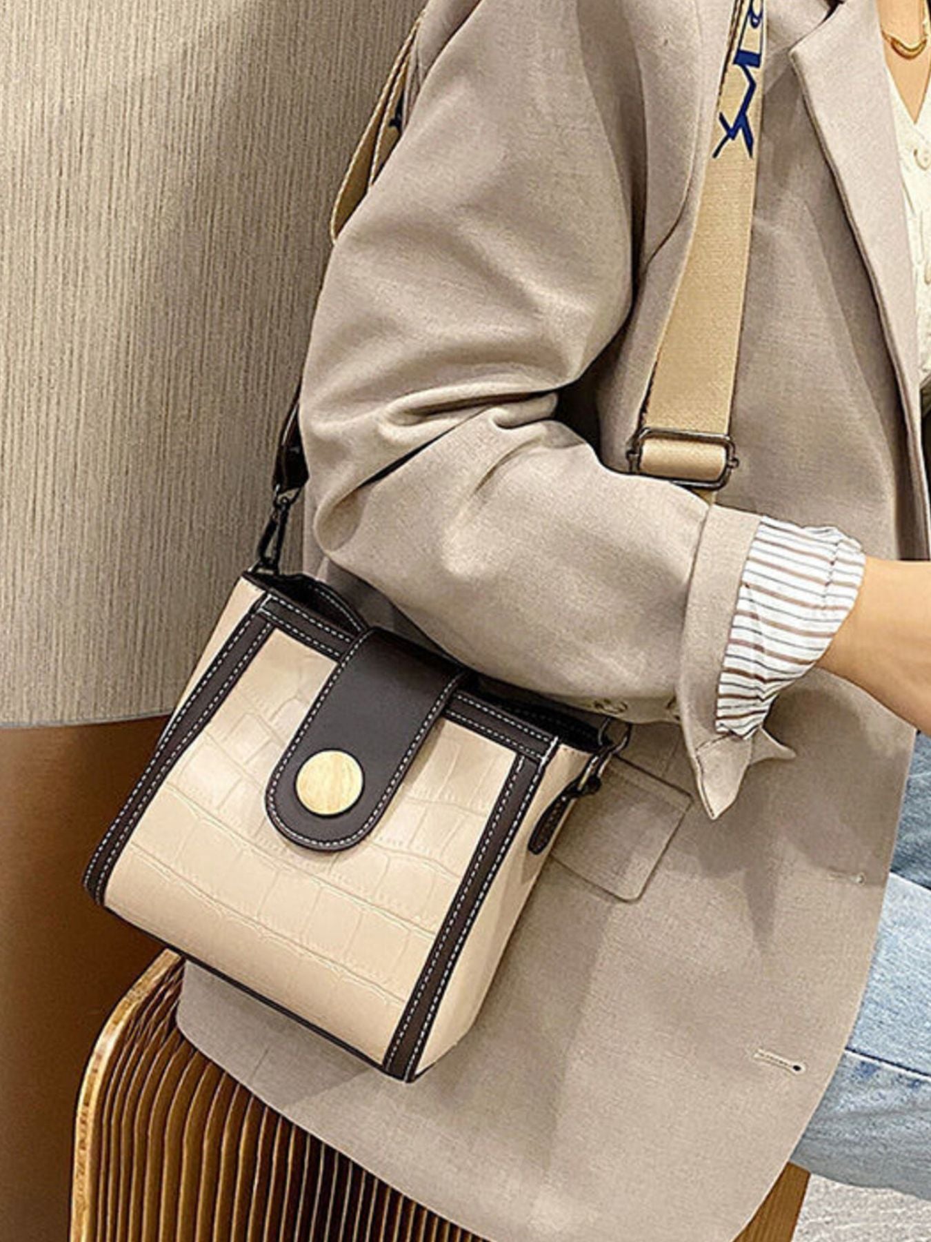 Khaki crocodile pattern mini crossbody bag with dark brown trim and gold button closure.