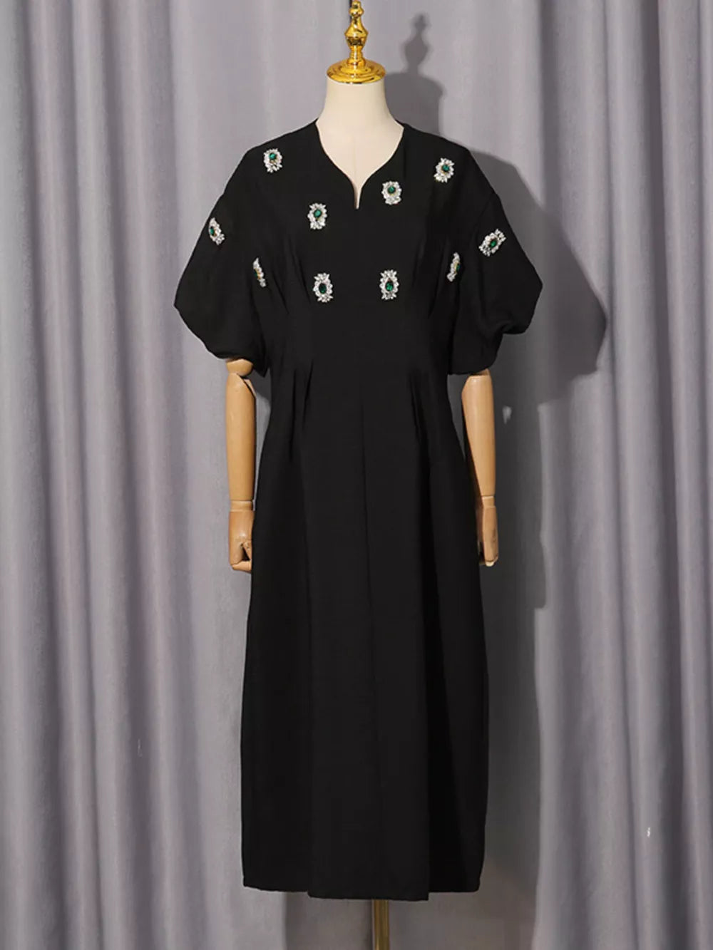 Black midi dress with puff sleeves and rhinestone embellishments.