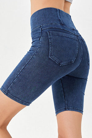 Denim bermuda shorts in dark blue with a crisscross waistband and back pockets.