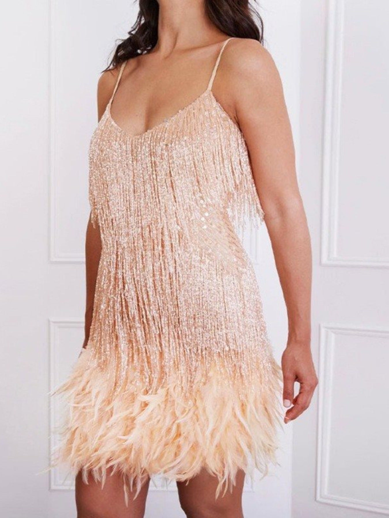 Beige mini dress with sequin fringe and feather hem.