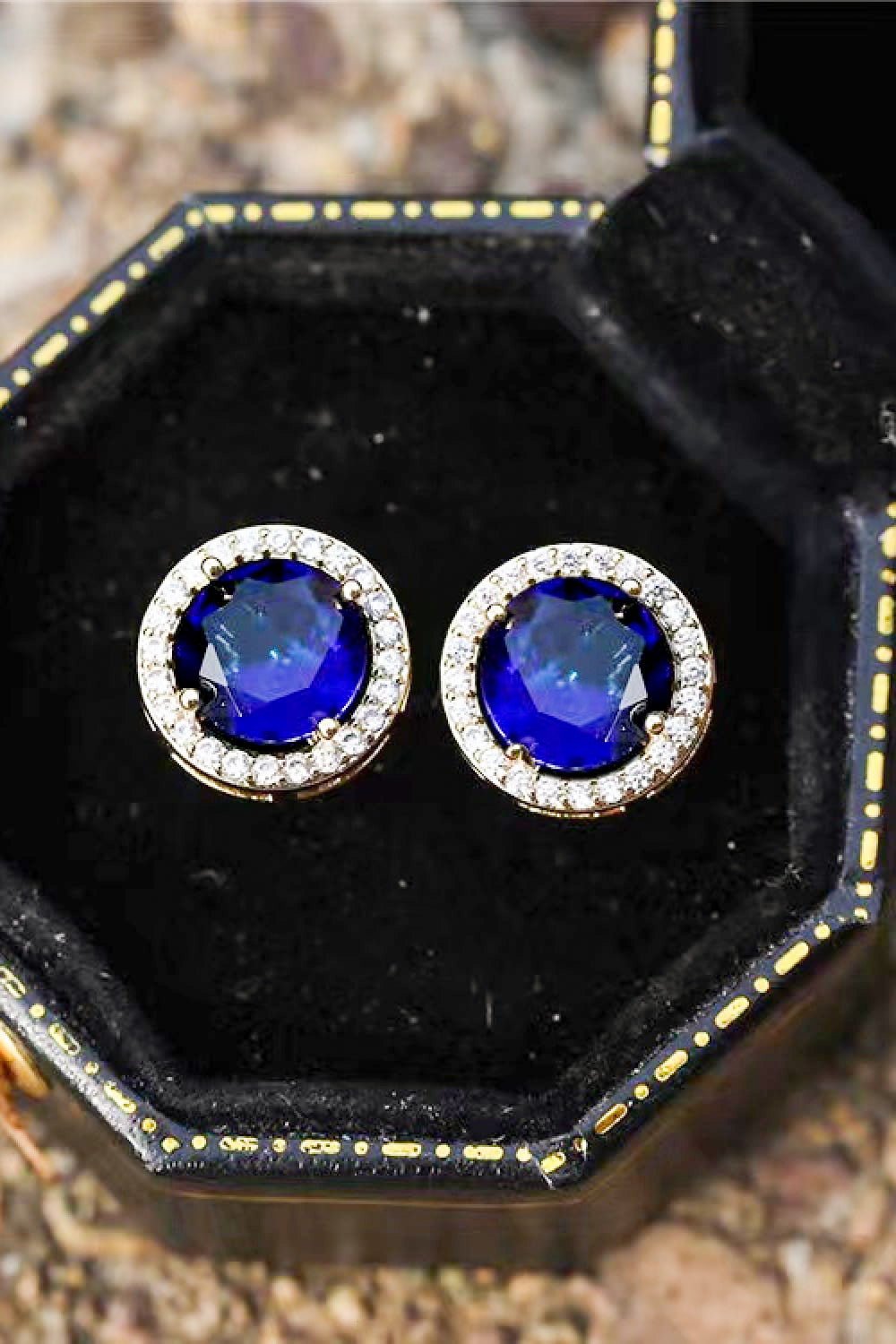 Blue sapphire halo stud earrings with diamond accents