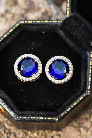 Blue sapphire halo stud earrings with diamond accents