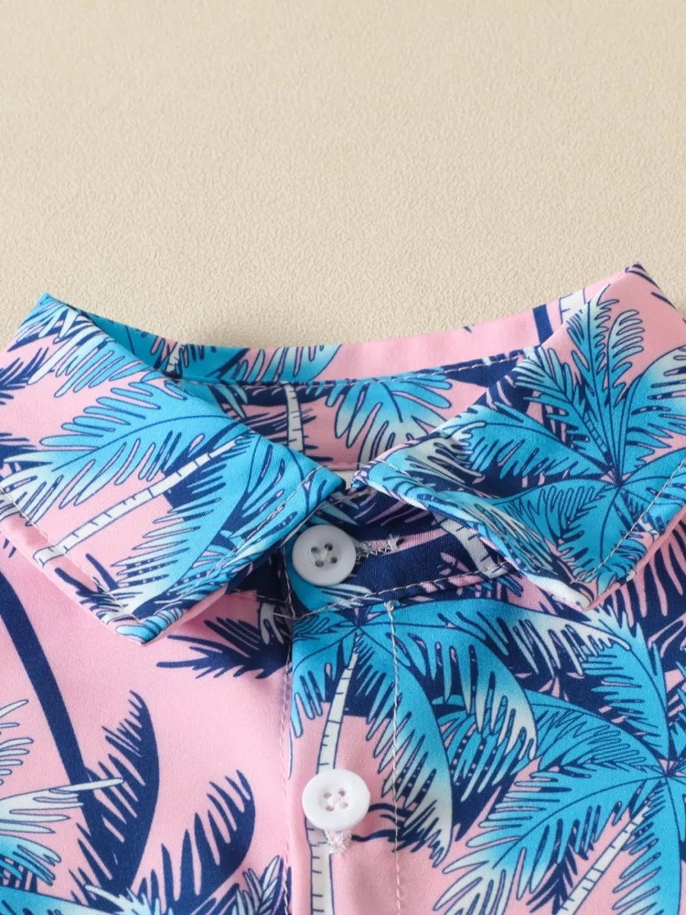 Baby shirt with pink, blue, and navy tropical palm print, cotton, button front.