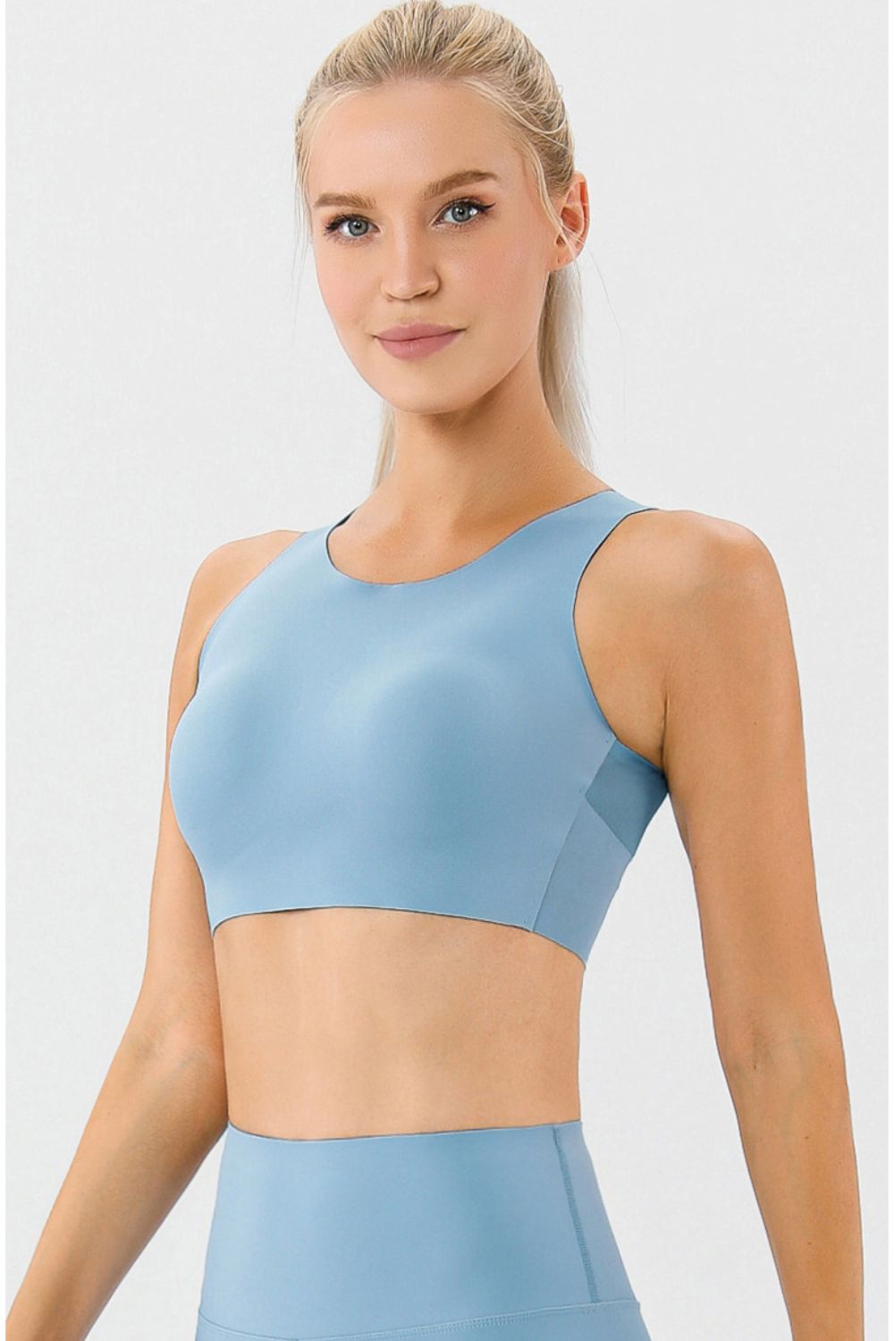 Light blue sports bra with a racerback and seamless design.