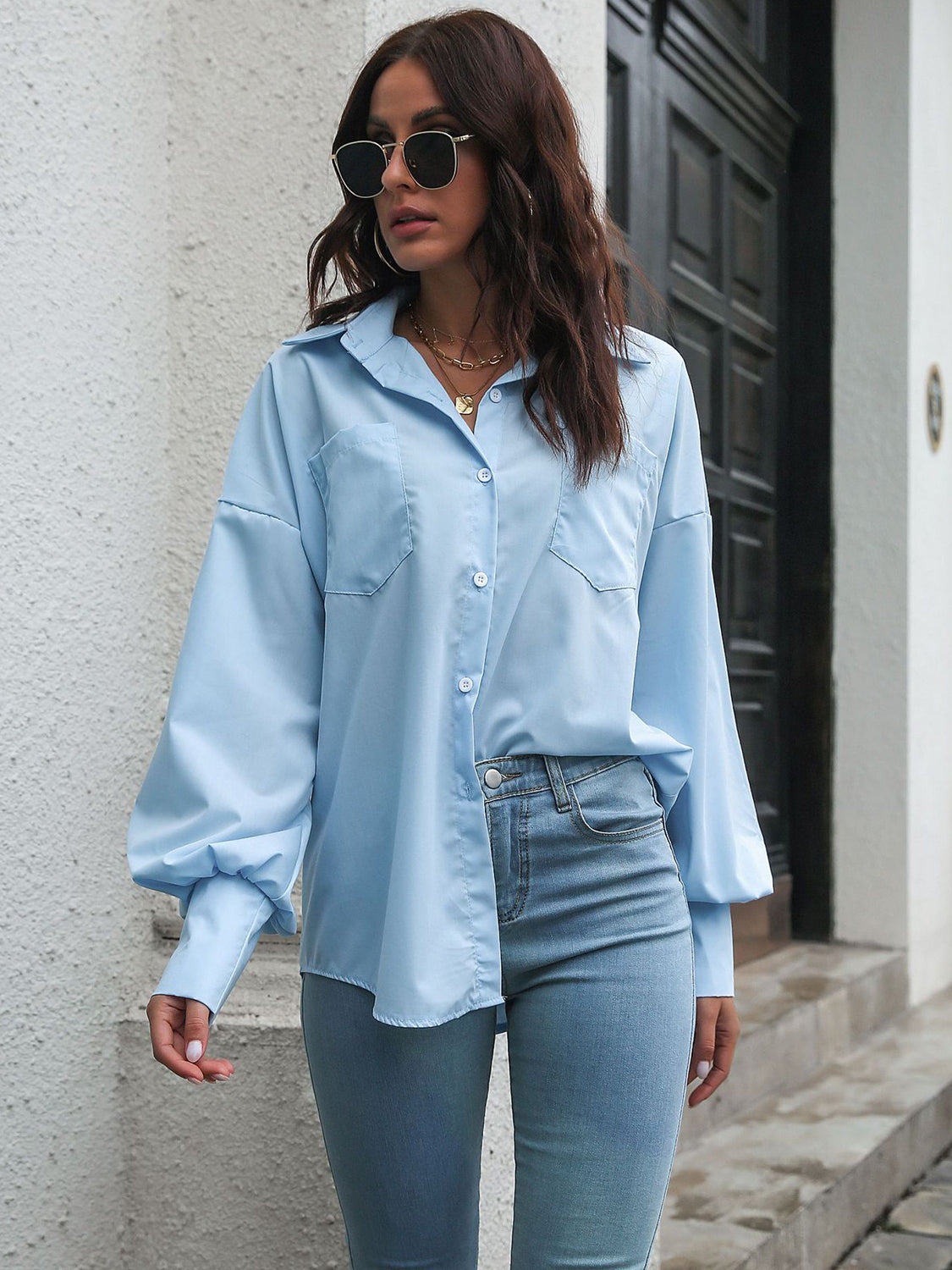 Blue poplin blouson sleeve shirt with button front and chest pockets.