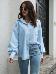Blue poplin blouson sleeve shirt with button front and chest pockets.