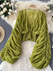 Green ruched sleeve blouse with deep V-neck and smocked waist