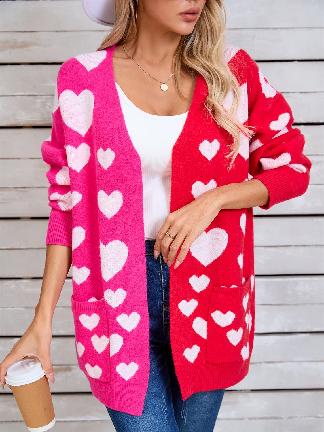 Heartbeat split-panel open cardigan in pink and red with white hearts, featuring pockets.