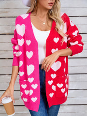 Heartbeat split-panel open cardigan in pink and red with white hearts, featuring pockets.