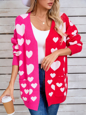 Heartbeat split-panel open cardigan in pink and red with white hearts, featuring pockets.