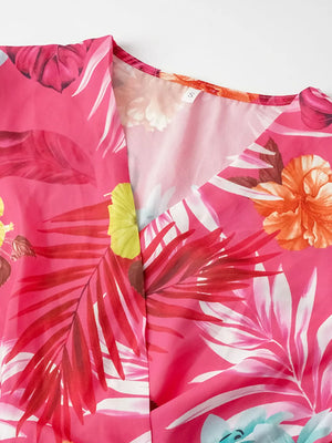 Hot pink tropical print midi dress with V-neck and pleats.